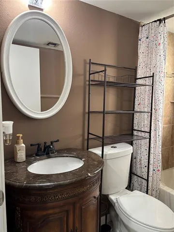 a bathroom with a sink toilet and a mirror