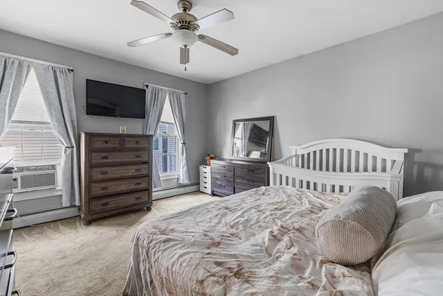 a bedroom with a bed and a tv