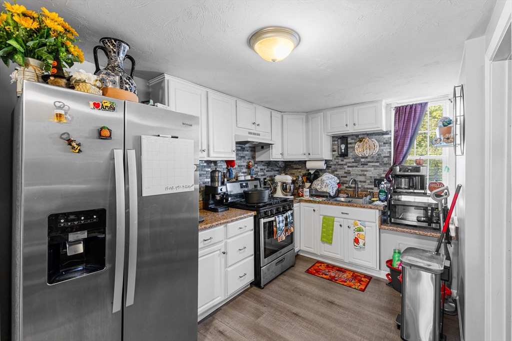 808 Walnut Street Fall River, MA 02720 - Photo 12 of 29 a kitchen with stainless steel appliances granite countertop a refrigerator and a stove