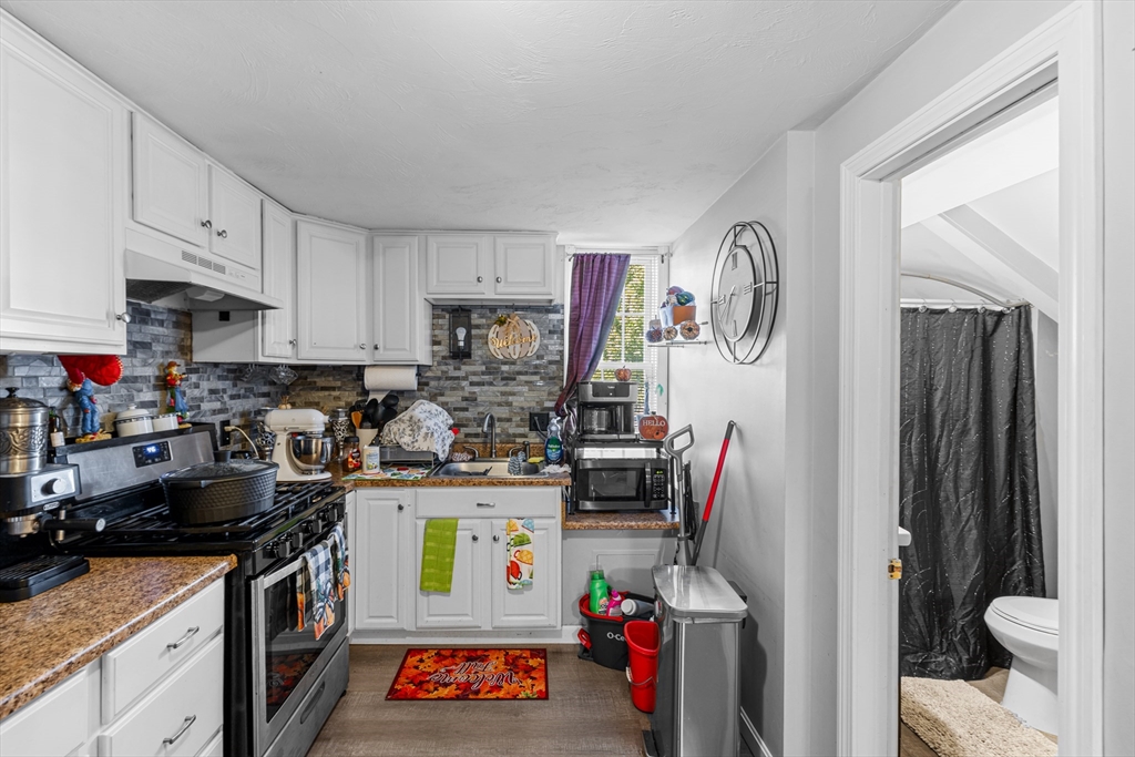 808 Walnut Street Fall River, MA 02720 - Photo 13 of 29 a kitchen with stainless steel appliances a stove a sink and a refrigerator