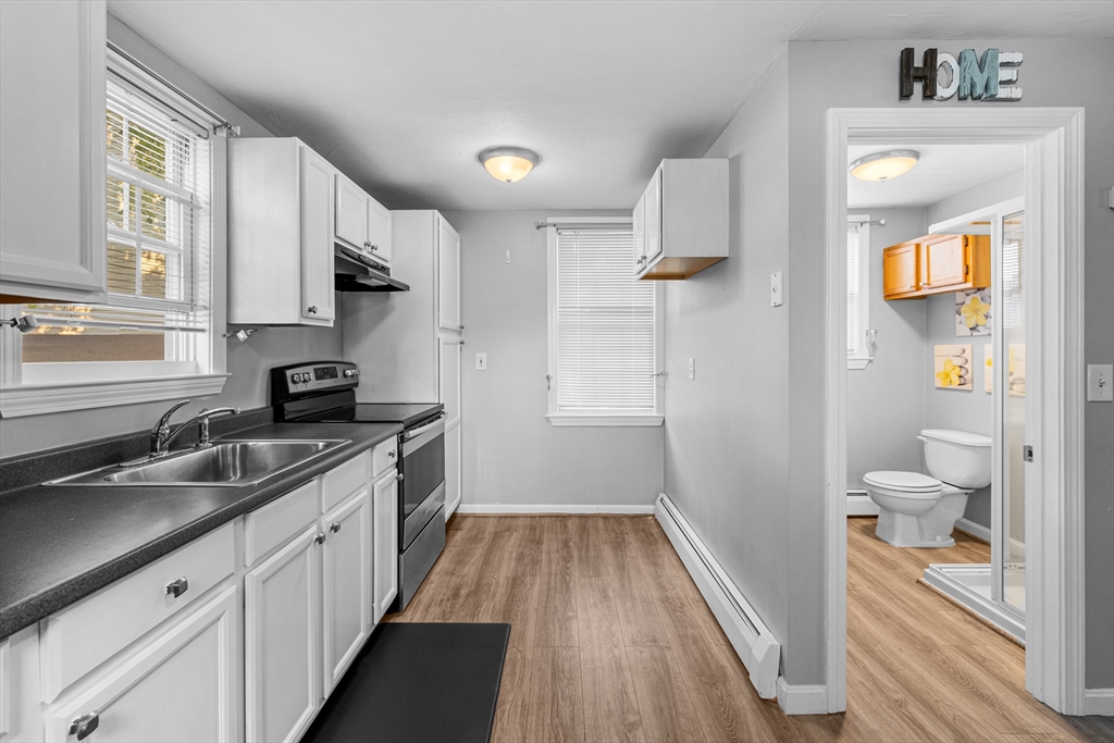 808 Walnut Street Fall River, MA 02720 - Photo 20 of 29 a kitchen with a sink and a refrigerator