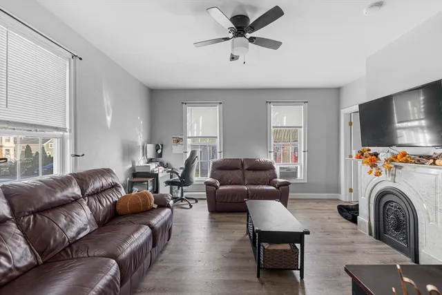a living room with furniture a flat screen tv and a fireplace