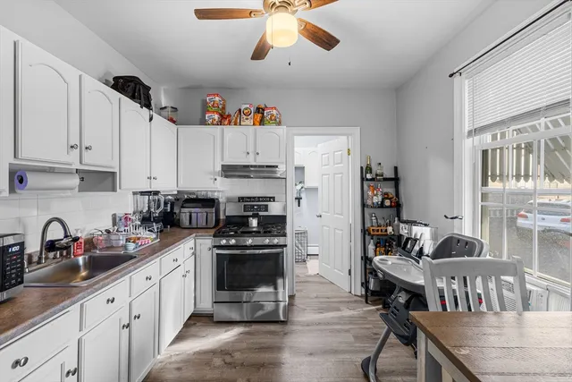 a kitchen with stainless steel appliances a stove a sink a refrigerator and cabinets