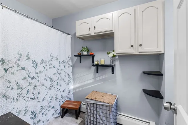 a bathroom with a sink and a wall painting