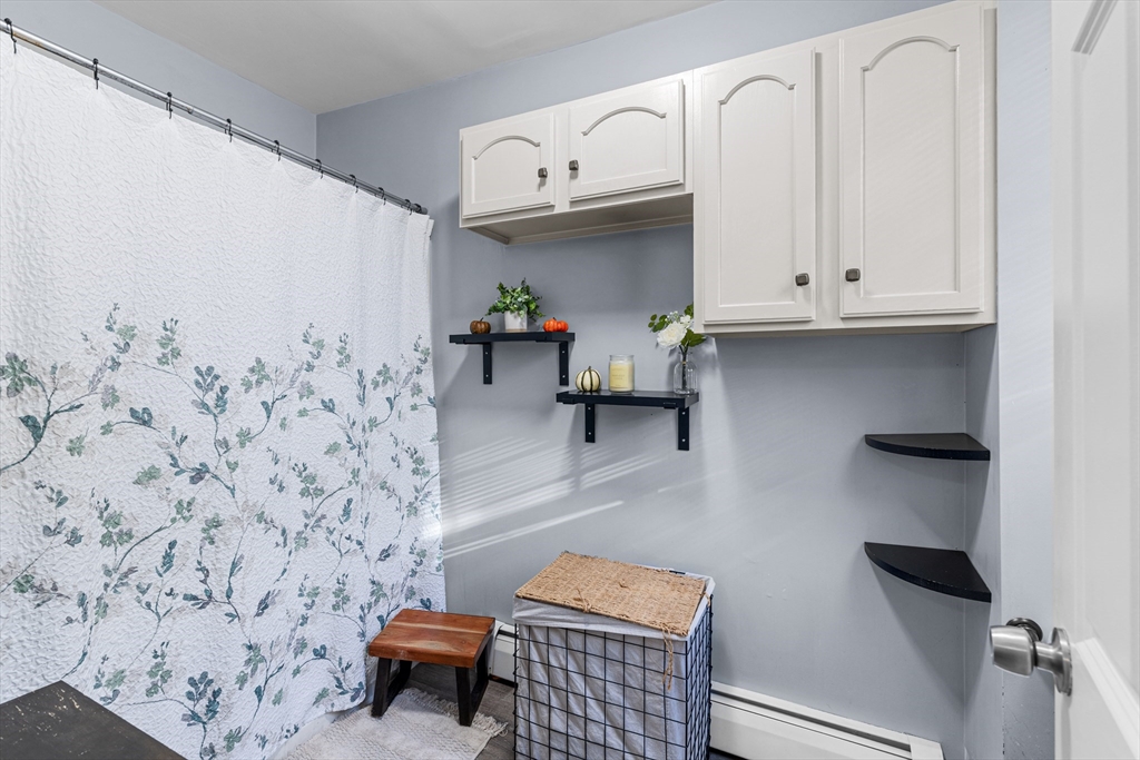 808 Walnut Street Fall River, MA 02720 - Photo 8 of 29 a bathroom with a sink and a wall painting