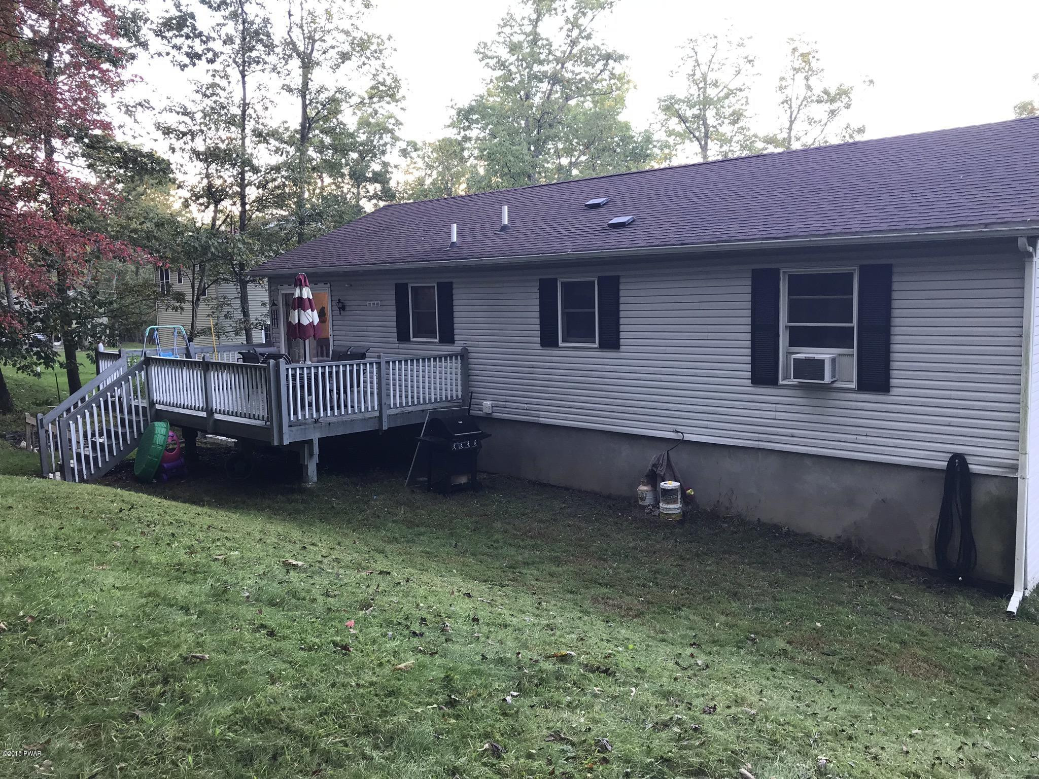 186 Gold Key Road Milford, PA 18337 - Photo 26 of 26 a backyard of a house with barbeque oven and table