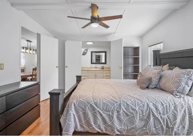 a bedroom with a large bed and a chandelier
