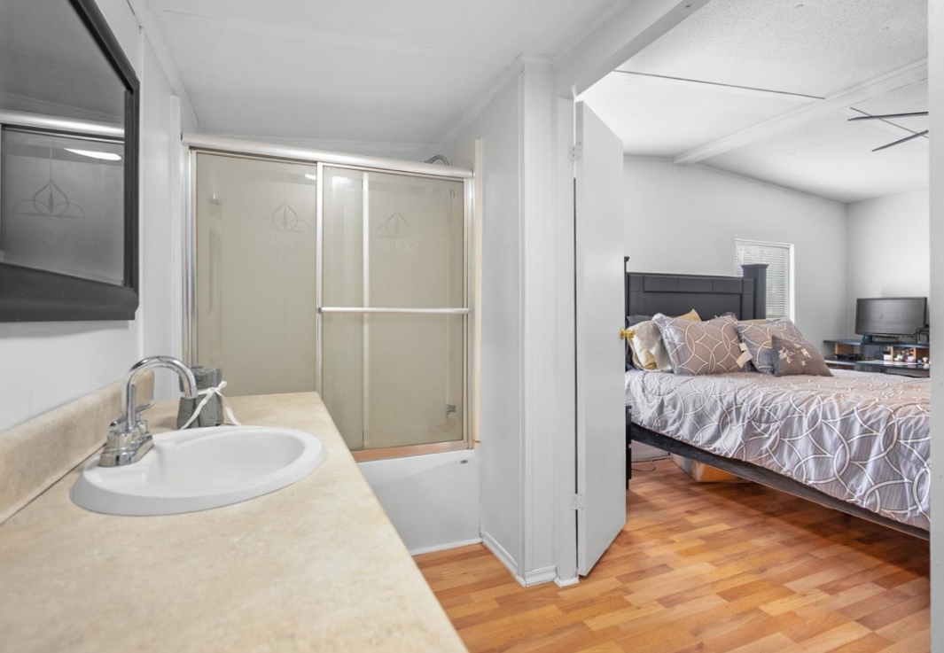 4410 Rues Landing Road St. Augustine, FL 32092 - Photo 12 of 19 a en suite bathroom with a double vanity sink and a mirror