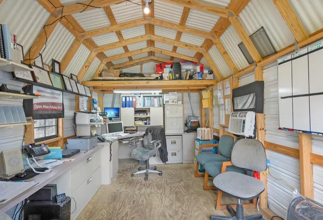 a work room with furniture and a large window