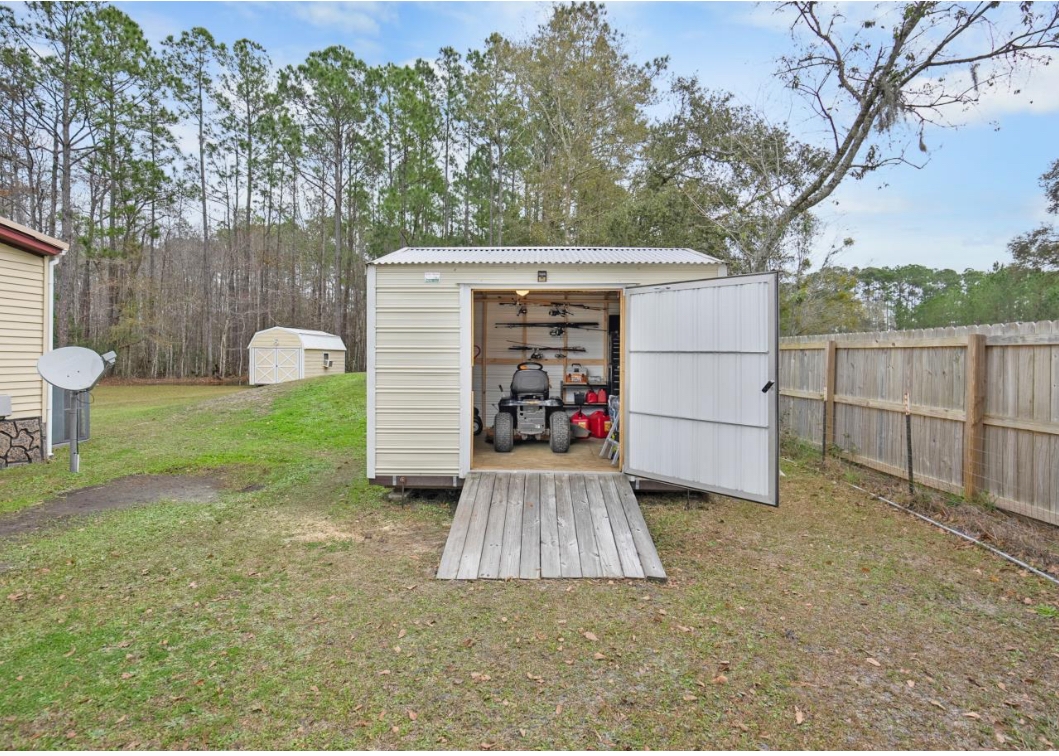 4410 Rues Landing Road St. Augustine, FL 32092 - Photo 17 of 19 a view of a chair and table in the back yard of the house