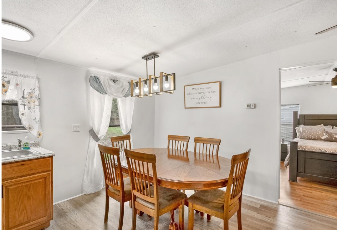 4410 Rues Landing Road St. Augustine, FL 32092 - Photo 6 of 19 a view of a dining room with furniture a chandelier and wooden floor