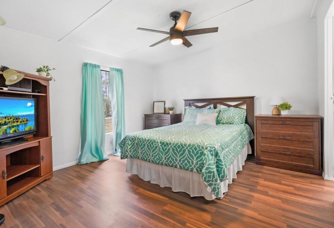 4410 Rues Landing Road St. Augustine, FL 32092 - Photo 9 of 19 a bedroom with a bed and a flat tv screen on dresser