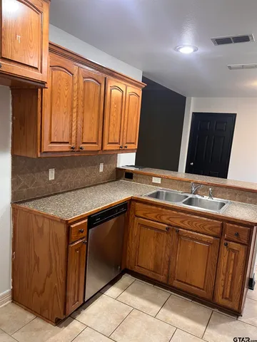 a kitchen with a sink and cabinets