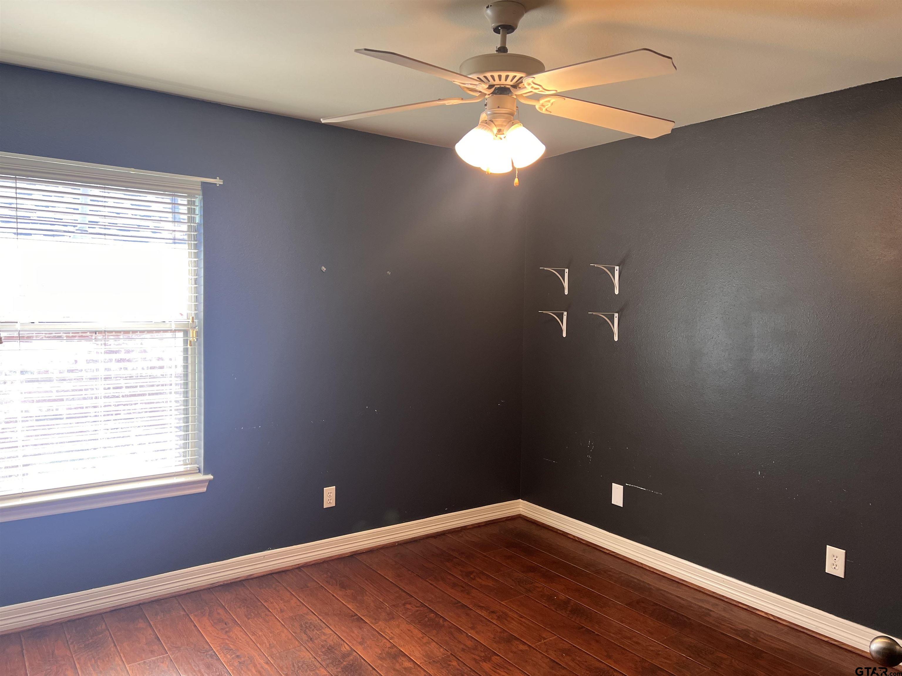 19482 Ruggles Court Flint, TX 75762 - Photo 15 of 16 an empty room with wooden floor and windows