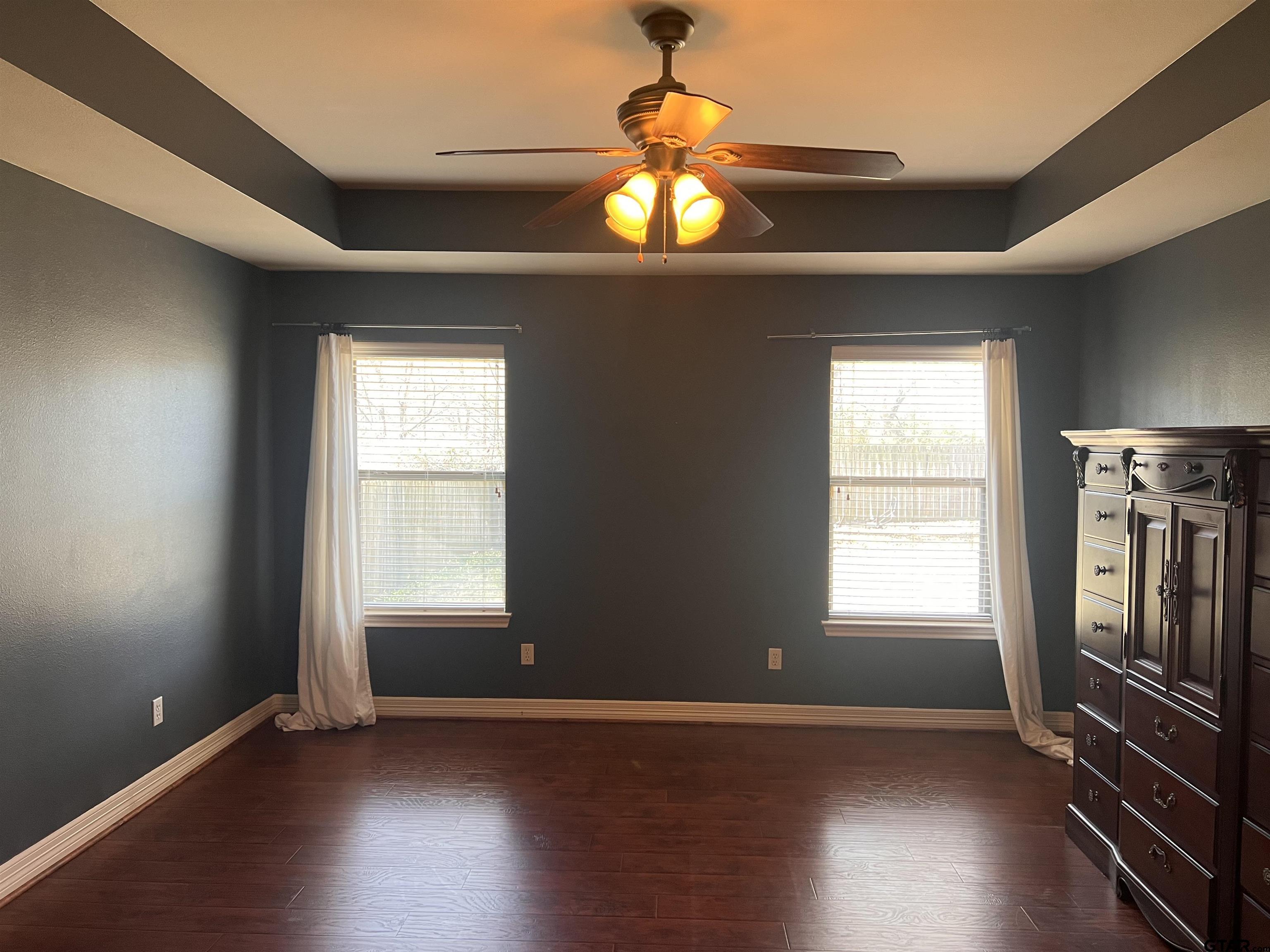 19482 Ruggles Court Flint, TX 75762 - Photo 5 of 16 an empty room with wooden floor chandelier and windows