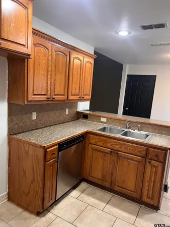 a kitchen with a sink and cabinets