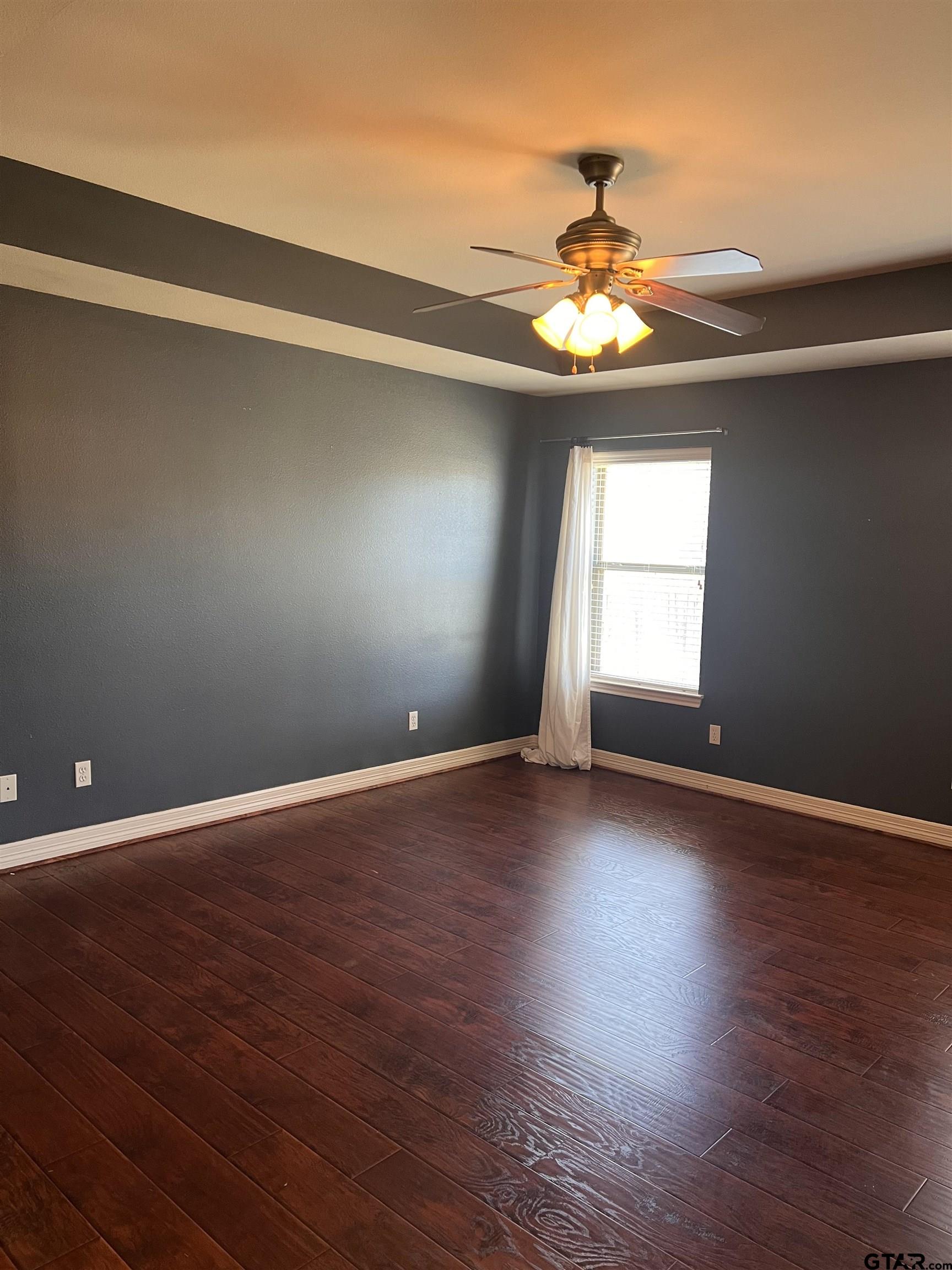 19482 Ruggles Court Flint, TX 75762 - Photo 7 of 16 a view of an empty room with window and wooden floor