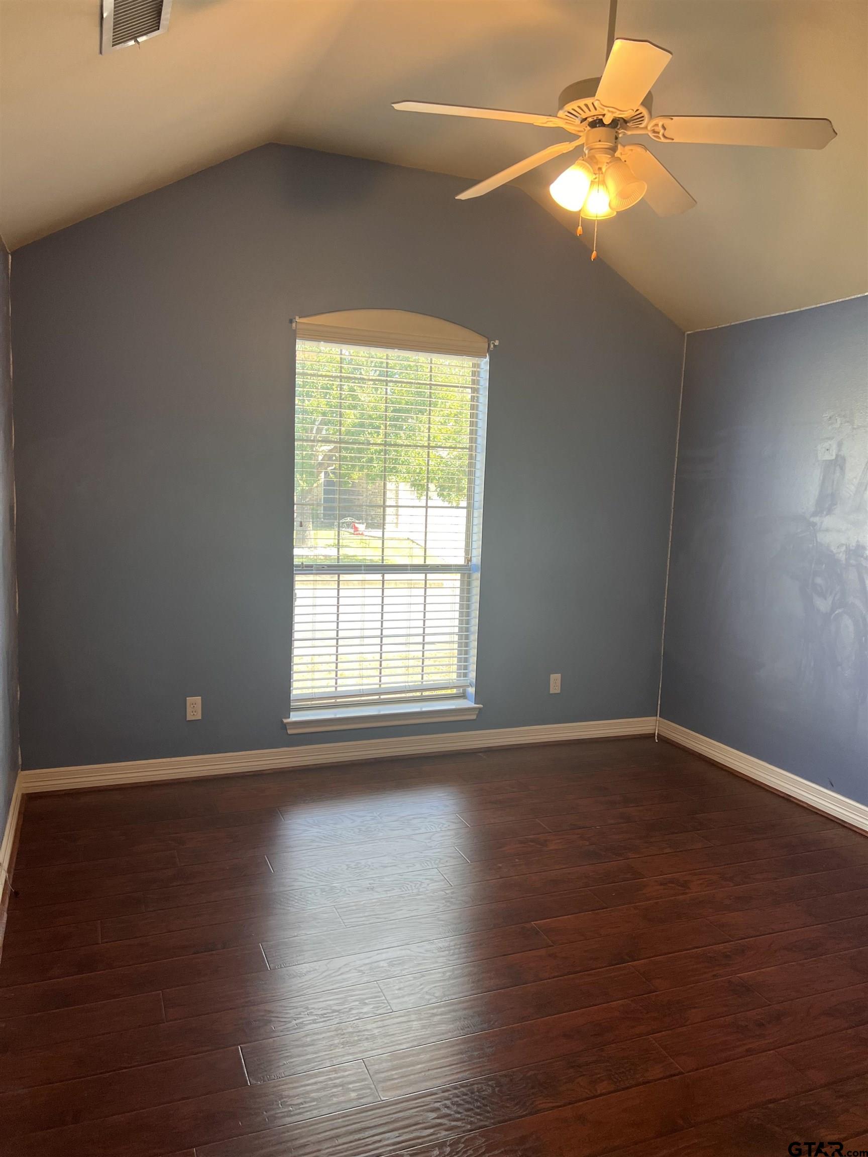 19482 Ruggles Court Flint, TX 75762 - Photo 8 of 16 a view of an empty room with wooden floor and a window