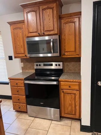 a stove top oven sitting inside of a kitchen