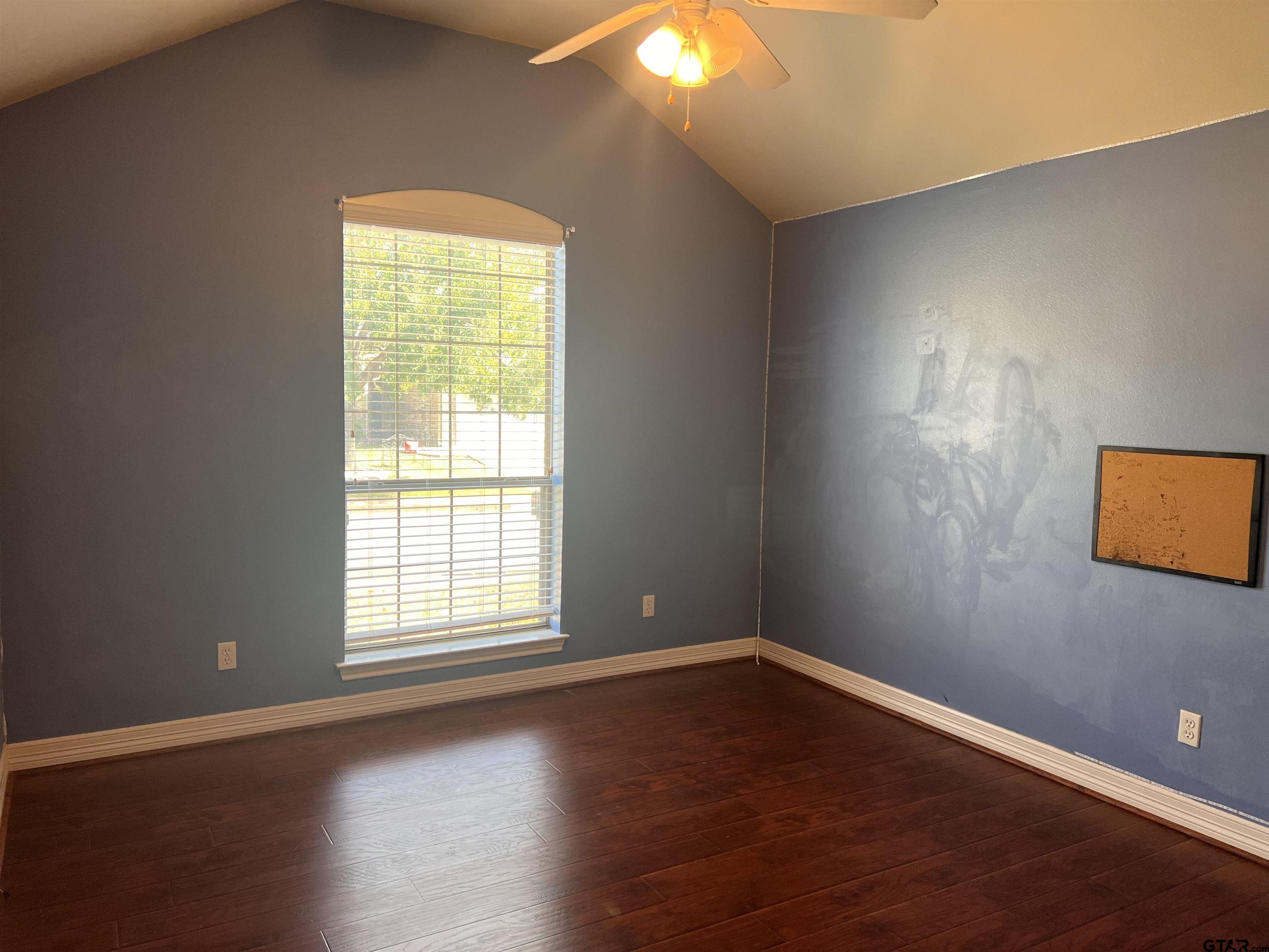 19482 Ruggles Court Flint, TX 75762 - Photo 9 of 16 an empty room with wooden floor and windows