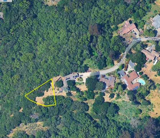 an aerial view of a house with swimming pool and garden