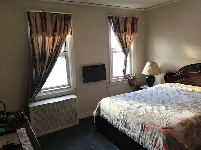 962 East 49th Street Brooklyn, NY 11203 - Photo 2 of 12 a bedroom with a bed next to a window with outer view
