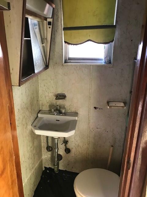 962 East 49th Street Brooklyn, NY 11203 - Photo 3 of 12 a bathroom with a sink and mirror with toilet