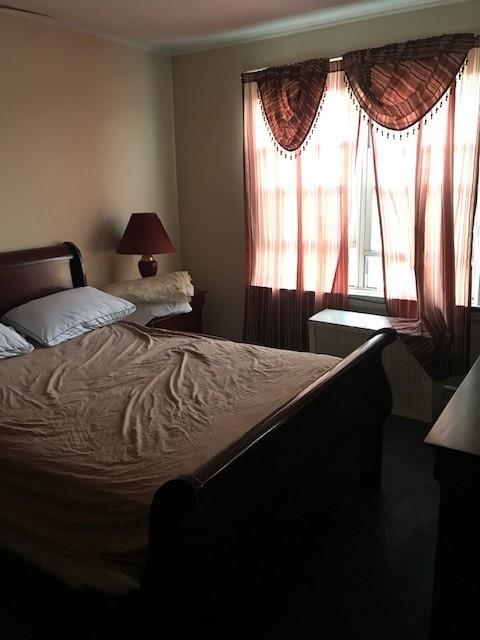 962 East 49th Street Brooklyn, NY 11203 - Photo 5 of 12 a bedroom with a bed and a window