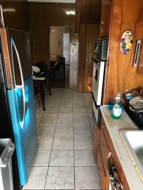 962 East 49th Street Brooklyn, NY 11203 - Photo 6 of 12 a kitchen with stainless steel appliances granite countertop a refrigerator and a stove