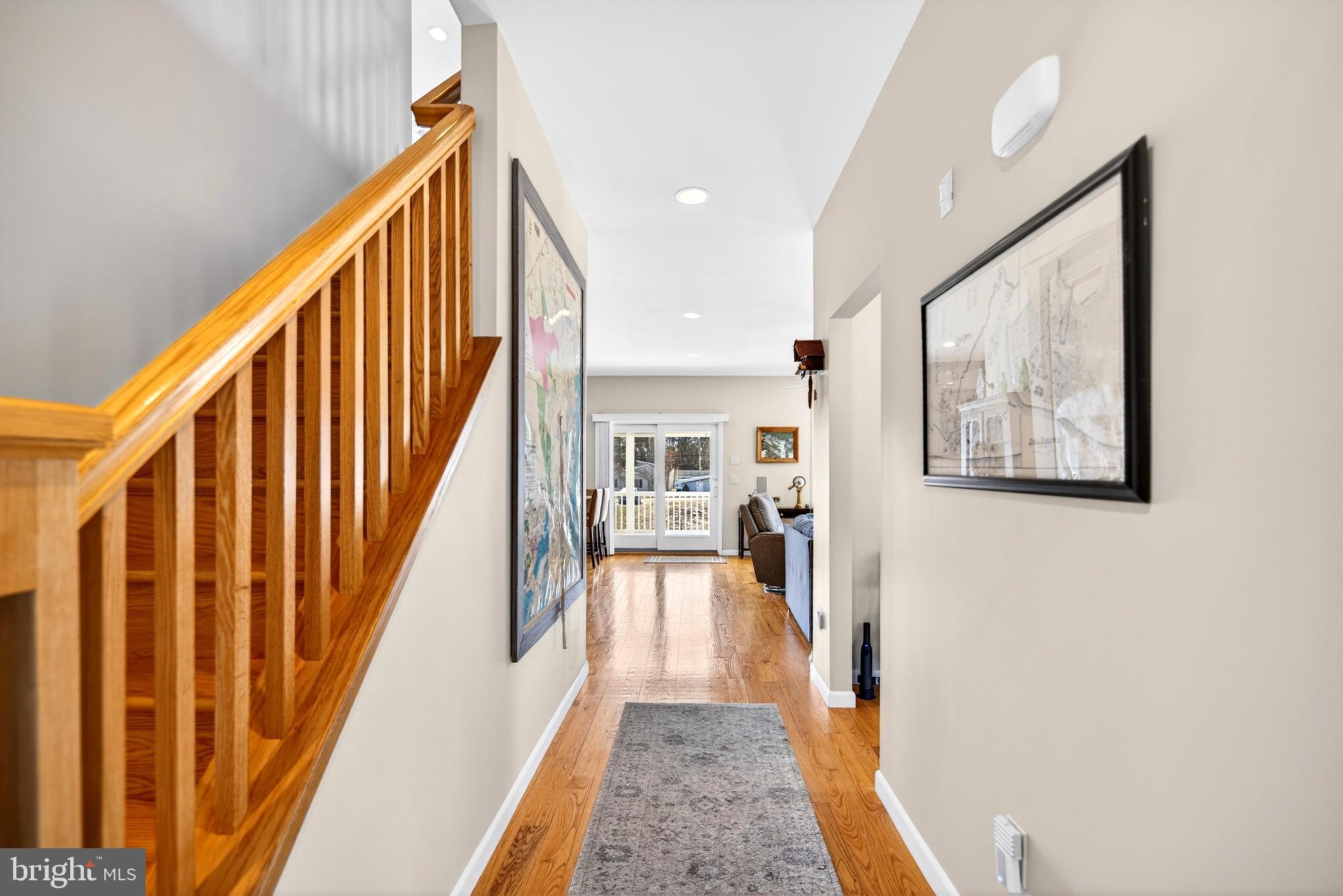20 Edgewater Drive Tuckerton, NJ 08087 - Photo 24 of 78 a view of a hallway with the couches and dining room with wooden floor