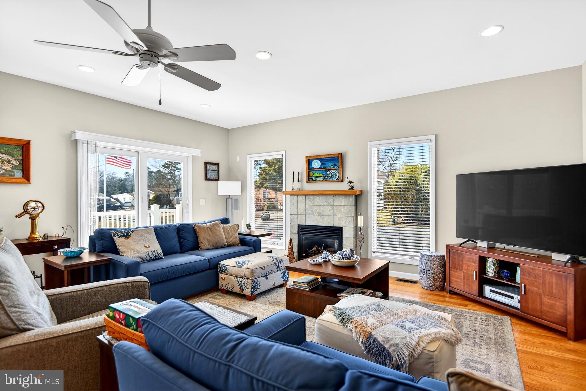20 Edgewater Drive Tuckerton, NJ 08087 - Photo 3 of 78 a living room with furniture a flat screen tv and a fireplace