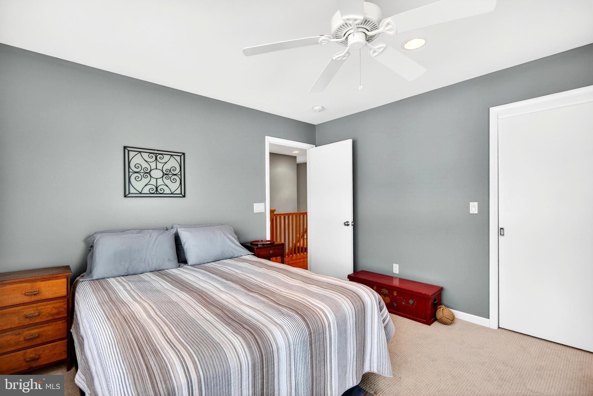 20 Edgewater Drive Tuckerton, NJ 08087 - Photo 38 of 78 a bedroom with a large bed and a chandelier