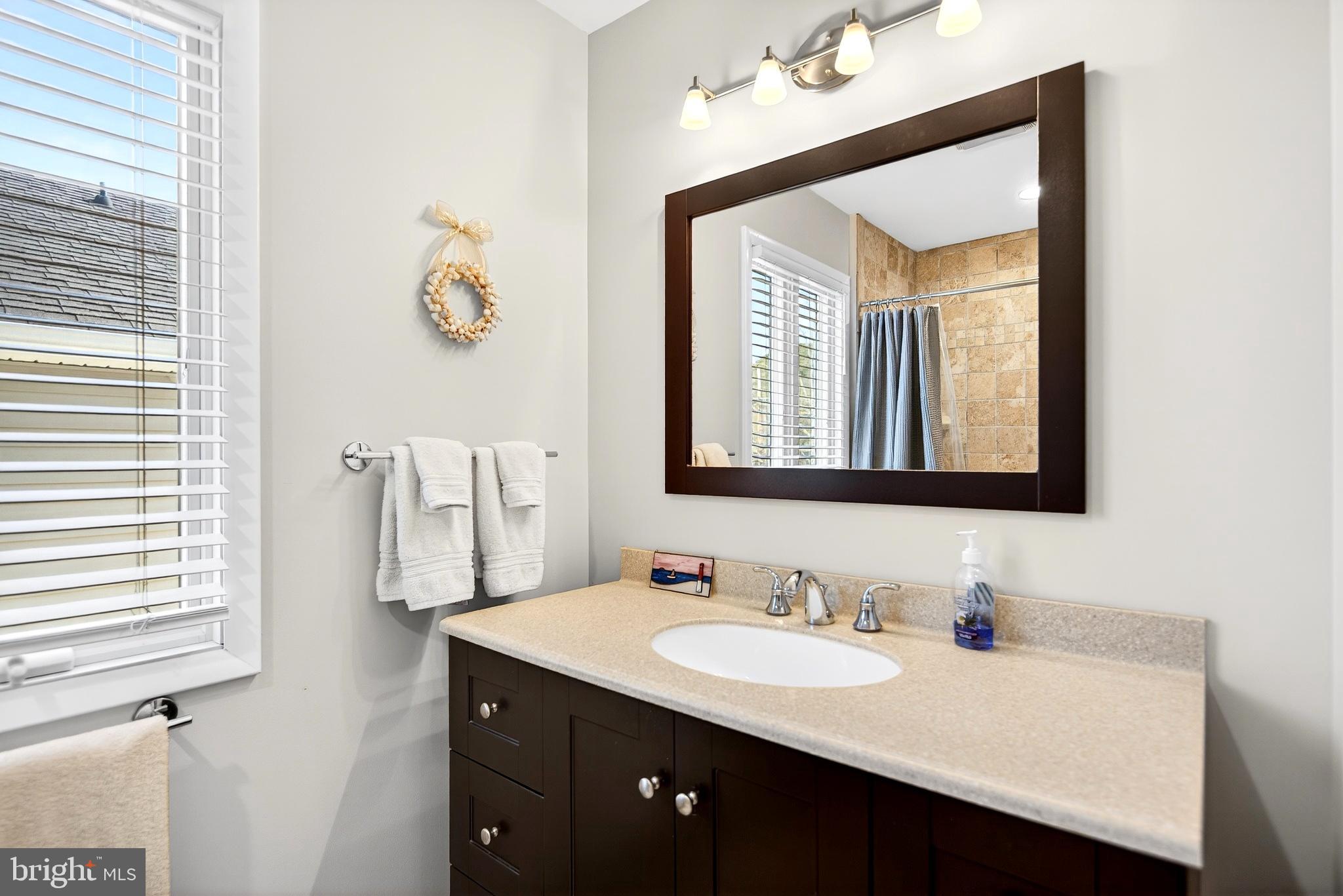 20 Edgewater Drive Tuckerton, NJ 08087 - Photo 48 of 78 a bathroom with a sink vanity and a mirror