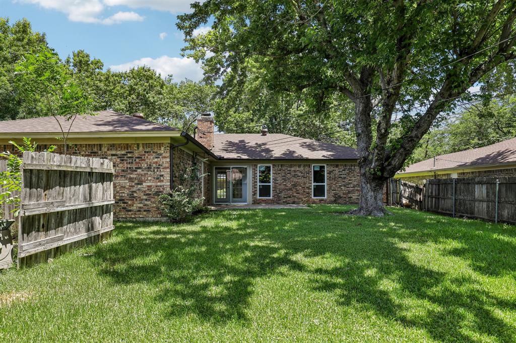 1600 South Timber Court Benbrook, TX 76126 - Photo 25 of 30 Expansive green lawn with a mature shade tree