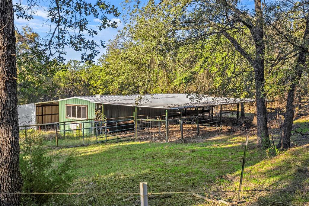 199 Cheyenne Trail Springtown, TX 76082 - Photo 7 of 22 a view of a house with backyard and sitting area