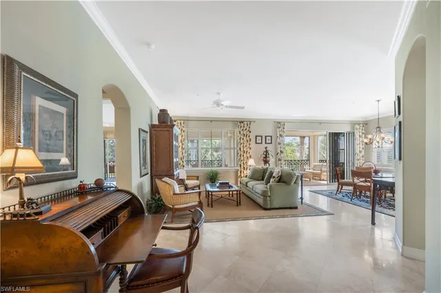 a living room with furniture and large windows