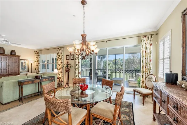 a dining room with furniture and a floor to ceiling window
