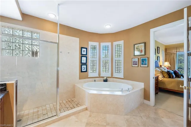 a bathroom with a tub and large window