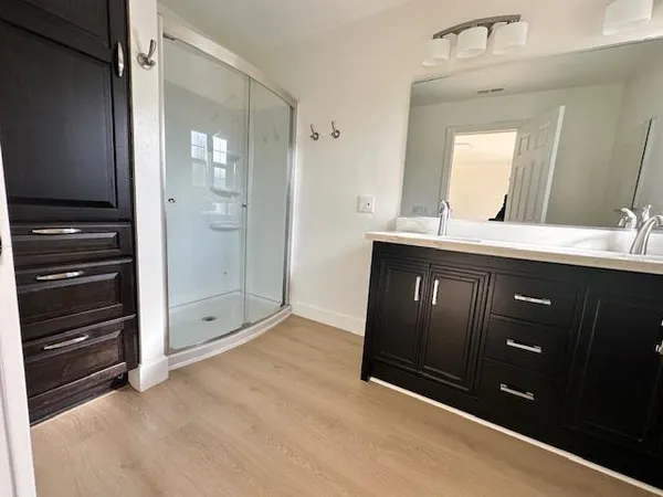 a spacious bathroom with a granite countertop sink mirror and