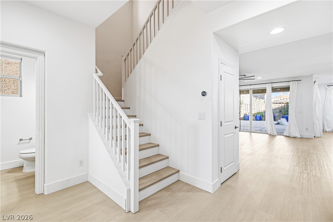 2182 Trivero Street Henderson, NV 89044 - Photo 6 of 50 Gleaming hardwood floors and a modern staircase anchor this open and airy entryway.