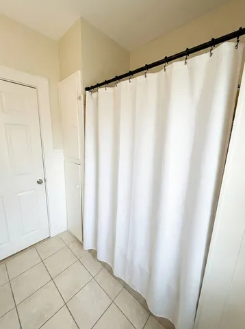 a view of a bathroom with a shower and a sink