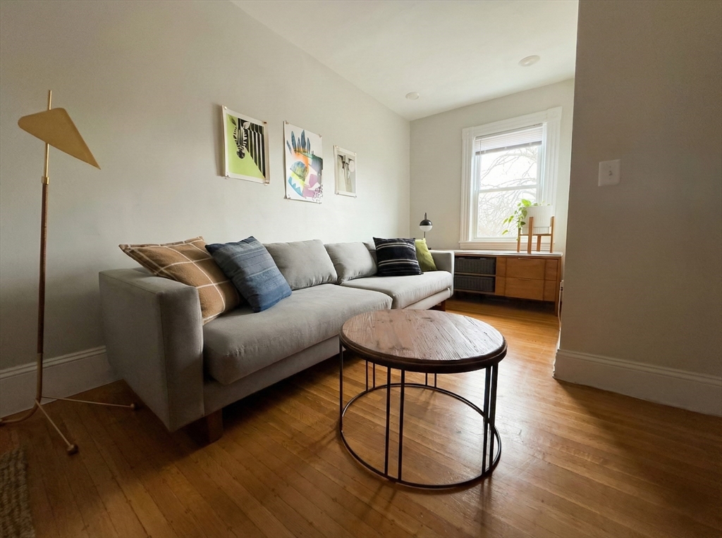 20 Fellsway West, Unit 2 Somerville, MA 02145 - Photo 4 of 17 a living room with furniture a window and wooden floor