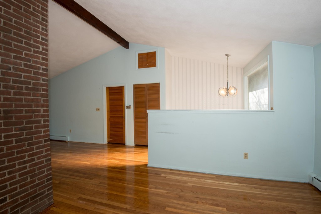 9 Fatima Road Stoneham, MA 02180 - Photo 12 of 26 a view of an empty room with wooden floor and a window