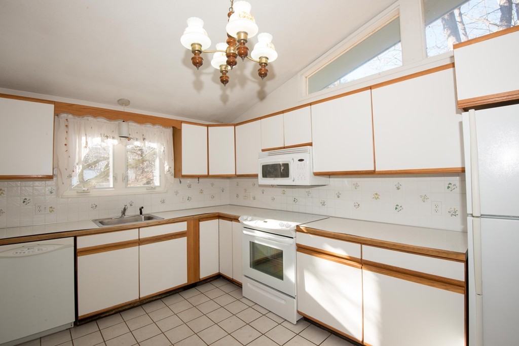 9 Fatima Road Stoneham, MA 02180 - Photo 13 of 26 a kitchen with a sink cabinets and window