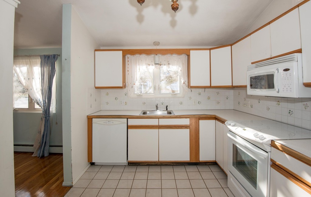 9 Fatima Road Stoneham, MA 02180 - Photo 14 of 26 a kitchen with a sink cabinets and window