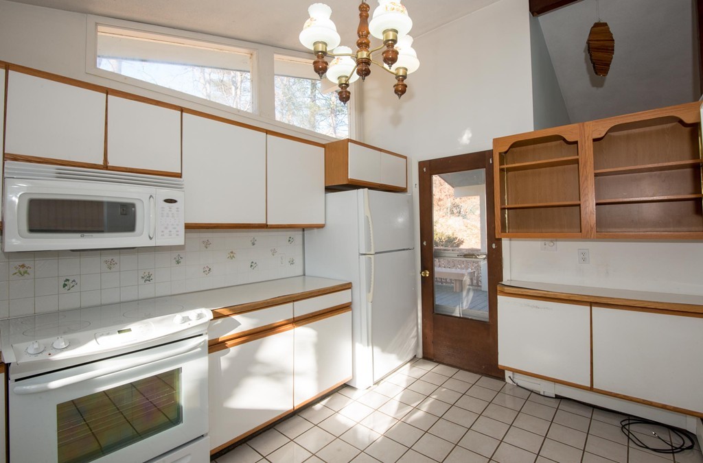 9 Fatima Road Stoneham, MA 02180 - Photo 15 of 26 a kitchen with cabinets and steel stainless steel appliances