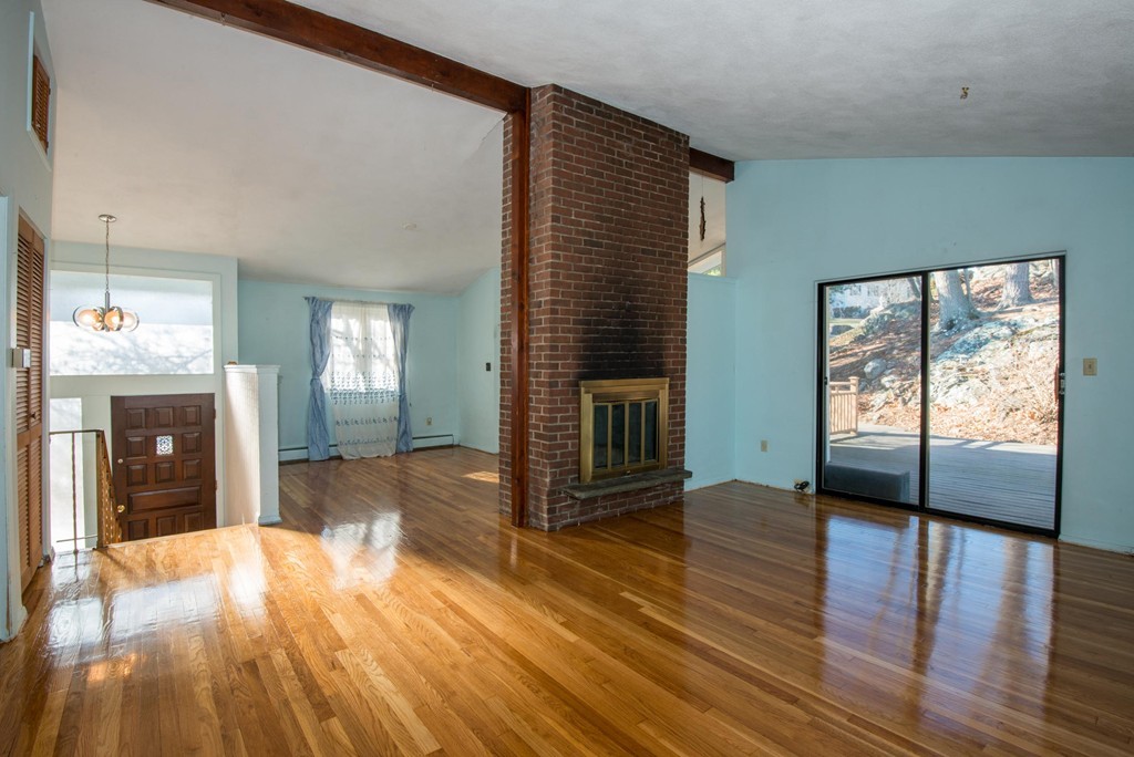 9 Fatima Road Stoneham, MA 02180 - Photo 7 of 26 a view of an empty room with wooden floor and a window