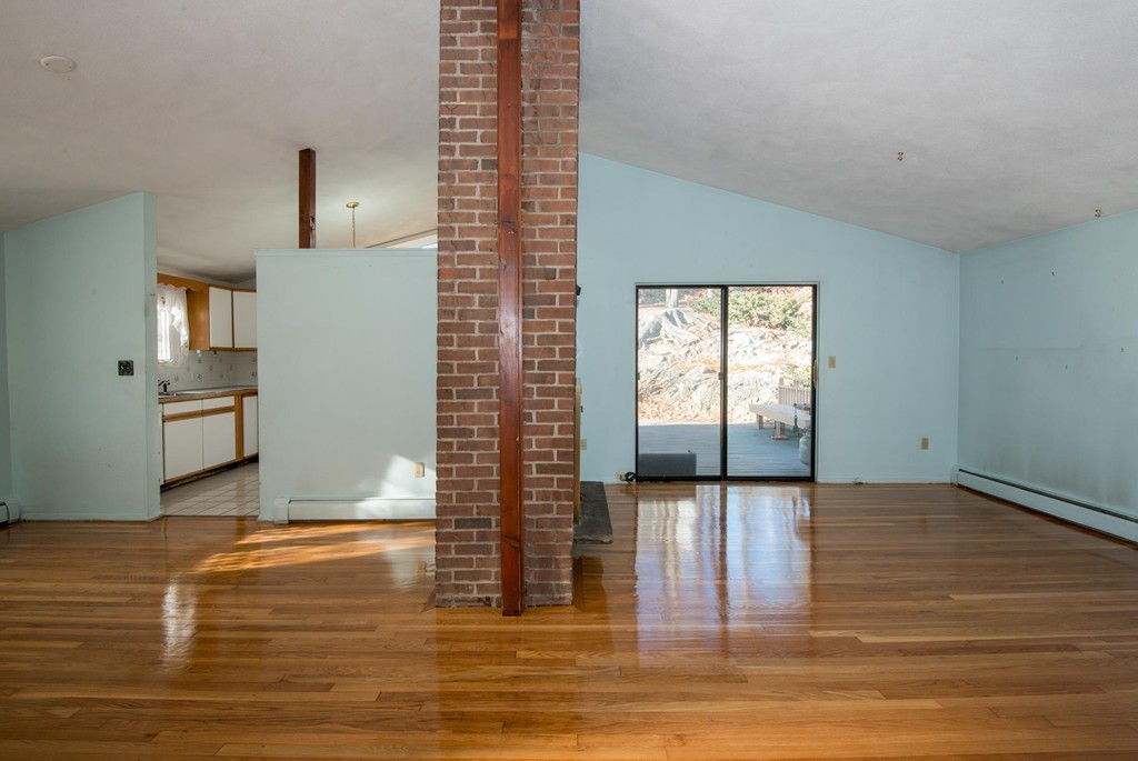 9 Fatima Road Stoneham, MA 02180 - Photo 8 of 26 a view of a kitchen with kitchen island a window and wooden floor