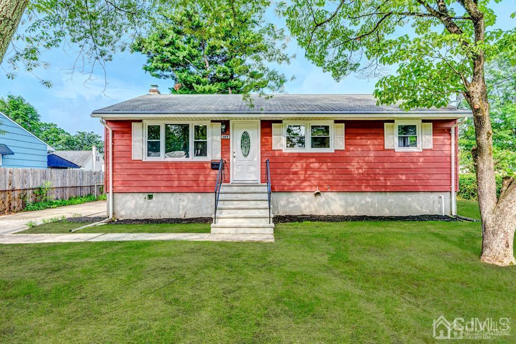 a front view of a house with a garden