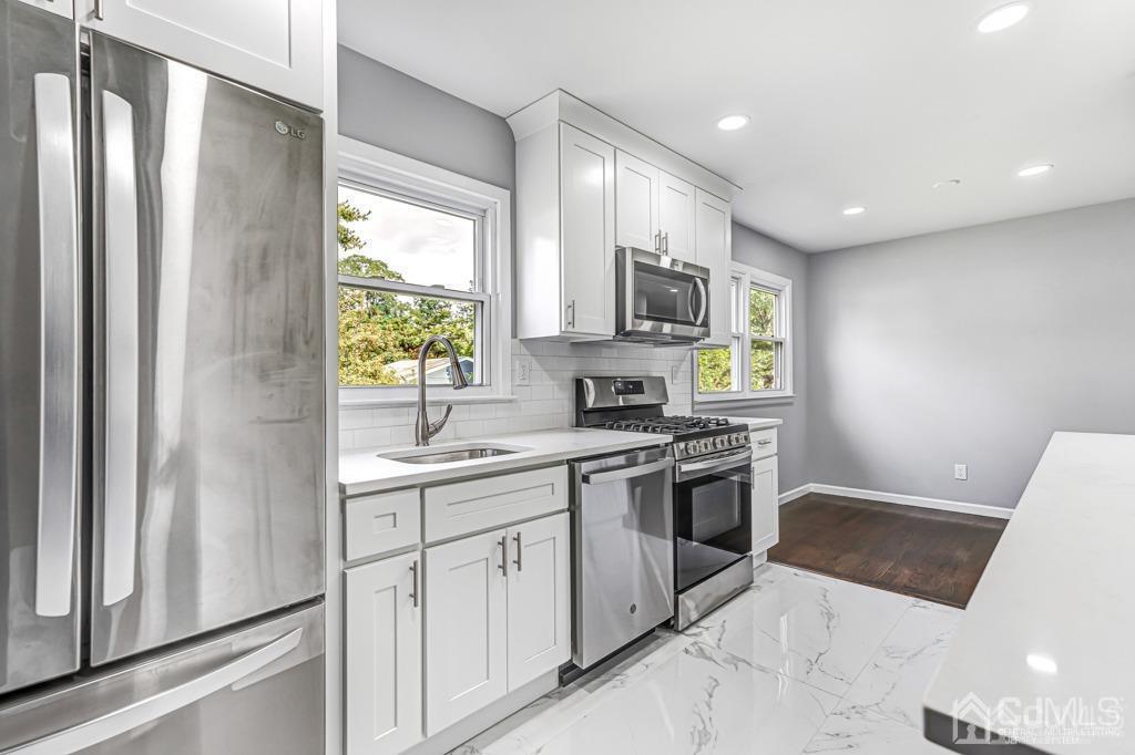 187 1st Street Middlesex, NJ 08846 - Photo 11 of 23 a kitchen with stainless steel appliances granite countertop a refrigerator and a sink
